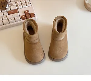 Top view of cozy children's tan snow boots with warm fleece lining for winter.