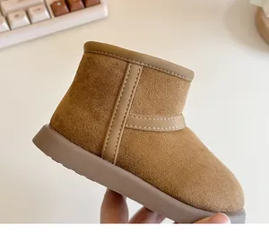Detailed close-up of children's tan suede snow boot showing fine stitching and thick sole