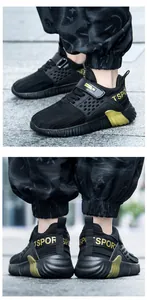 Close-up of black breathable mesh children's sneakers with gold 'SPORT' lettering details
