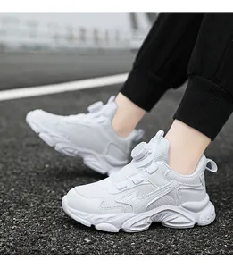 Detail of white breathable boys sports sneakers worn on a road surface