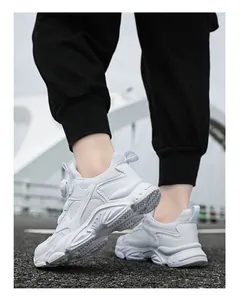 Detailed close-up of white breathable lightweight chunky sneakers for boys on asphalt