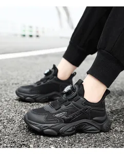 Close-up of boys black chunky sneakers with breathable mesh and swivel buckle
