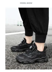 Close-up of boys' black breathable chunky sneakers with rotary closure system