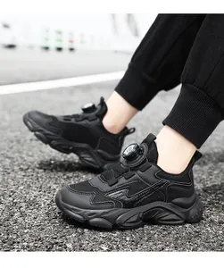 Detailed view of boys black breathable sports sneakers with a rotating buckle system