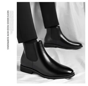 Detail view of black leather Chelsea boots with elastic side panels and sleek finish