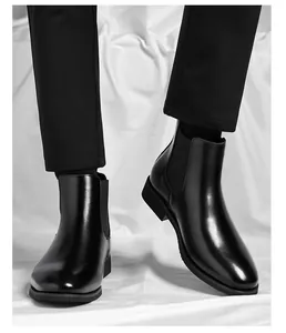 Detail view of stylish black leather Chelsea boots for men on model