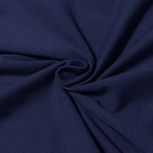 Detailed macro view of soft navy blue cotton fabric showing the fine knit texture and folds