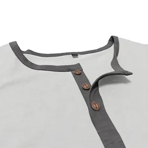 Detailed view of men's cotton Henley shirt neckline with buttons and grey contrast trim