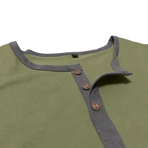 Detail macro view of olive green cotton Henley shirt showing the collar and buttons