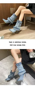Detailed view of blue denim pointed-toe stiletto boots with unique pant-leg fold.