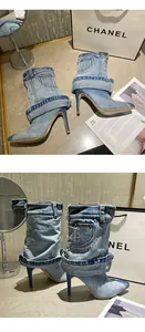 Detail of denim pointed-toe stiletto boots with trendy slouchy trouser design