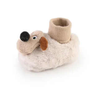 Close-up of plush baby winter sock shoes featuring a cute cartoon dog head design.