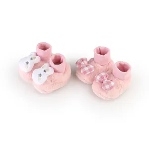 Cozy pink plush baby winter floor shoes featuring cute rabbit and plaid bow decorative details