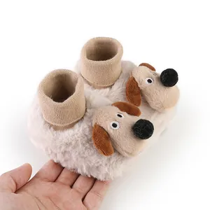 Close-up view of soft plush baby winter booties featuring a cute 3D puppy dog design