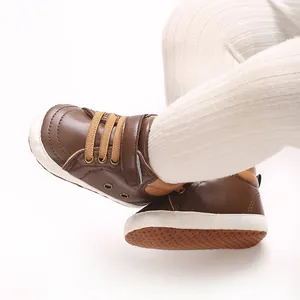 Vista dettagliata di scarpe alte in pelle PU marrone per neonati con suole antiscivolo bianche