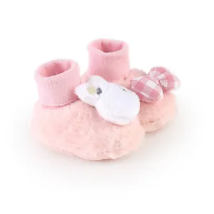 Soft pink fuzzy baby girl booties featuring a white bunny and pink checkered bow detail