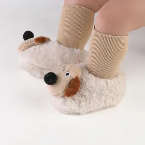 Close-up detail of plush baby winter booties featuring a cute 3D cartoon puppy dog design