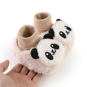Close-up of baby winter plush socks with cute 3D panda character design for newborns