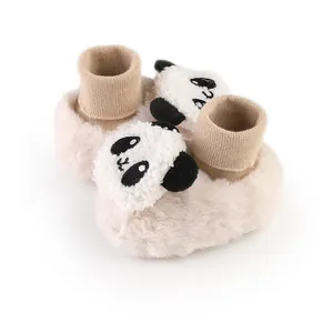 Close-up of baby winter fleece booties with cute plush panda head decoration