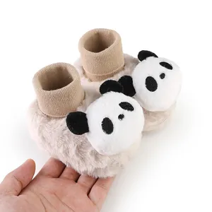 Close-up of fuzzy baby winter floor socks with cute plush panda face decorations for newborns