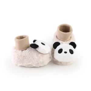 Close-up detail of the 3D panda decoration on beige plush baby winter floor socks