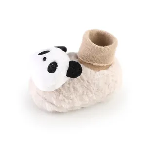 Close-up of baby winter fleece-lined floor socks with a plush panda decoration