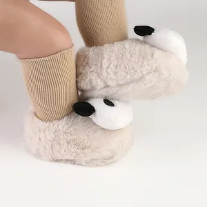 Detailed view of soft plush baby winter pre-walker shoes with cute panda design and knit socks