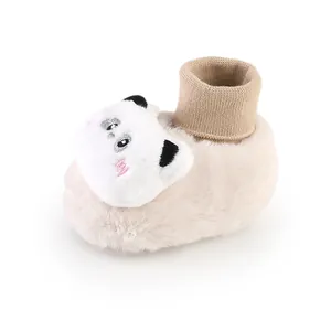 Soft beige baby winter plush sock shoe featuring a cute white cartoon bear face detail.