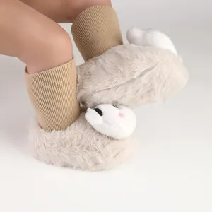 Close-up of cute rabbit plush baby winter slippers with warm ribbed sock cuffs