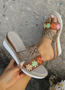 Bohemian wedge sandals with colorful floral embroidery and textured jute platform soles.