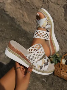 Detailed view of butterfly print platform sandals with woven rope sole and mesh strap