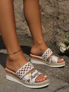 Close-up detail of women's wedge platform sandals featuring butterfly print and woven straps