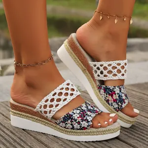 Detail view of women's floral and white woven wedge sandals with stylish rope sole.