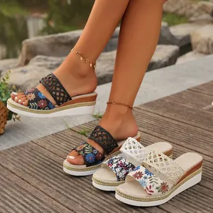 Detailed view of women's wedge sandals with floral embroidery and woven rope platforms