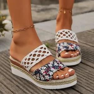 Detailed close-up of floral print and white crochet straps on women's rope wedge sandals