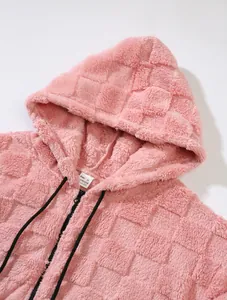Close-up of pink fleece hooded jacket showing textured check pattern and zipper