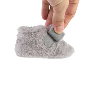 Detail of grey fluffy winter baby bootie with soft fleece texture and hook-and-loop closure