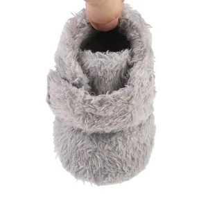 Detailed view of the soft grey plush material and lining on a baby winter shoe