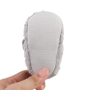 Detailed view of the white non-slip sole on soft gray plush winter baby walking shoes