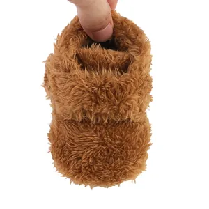 Close-up of soft brown plush baby winter shoe with warm thickened lining
