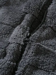 Macro detail of high-quality fleece texture and durable zipper on grey winter jacket