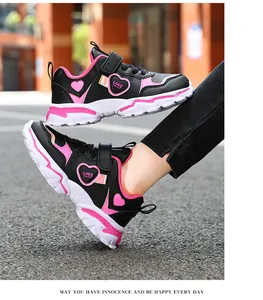 Girls black and pink sports sneakers with cute heart pattern detail on foot