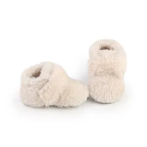 Close-up of soft cream baby winter booties featuring warm plush lining and thick fuzzy texture