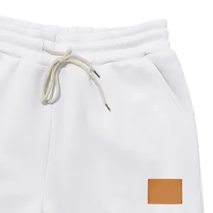Primer plano del detalle de la cintura elástica de un pantalón blanco de hombre con cordón