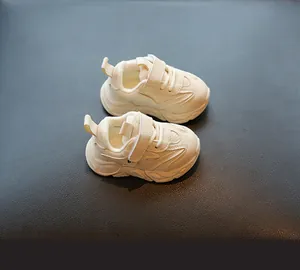 Vista detallada de zapatillas de bebé color crema con forro de terciopelo y velcro.