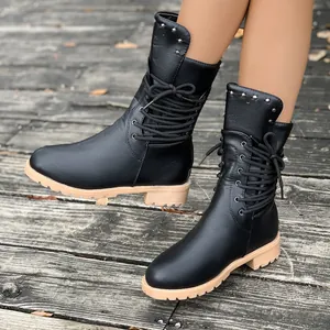 Detailed view of black mid-calf knight boots featuring side lacing and silver studs.