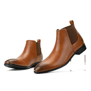Side profile of brown men's Chelsea boots with small square toe and elastic panel