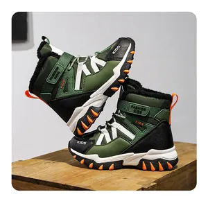 Close-up of boys' warm green fur-lined winter snow boots with non-slip soles and straps