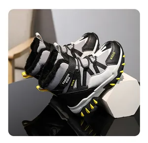 Detail of kids' winter snow boots with warm fleece lining and yellow anti-slip spikes.