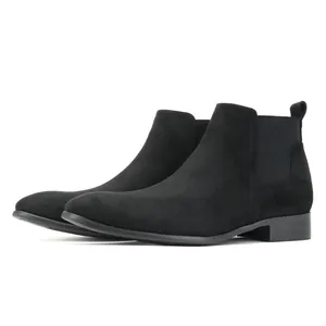 Macro view of men's black suede Chelsea boots with a stylish small square toe design.